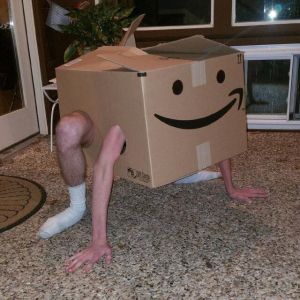 Guy in an Amazon box with a smiley face on it