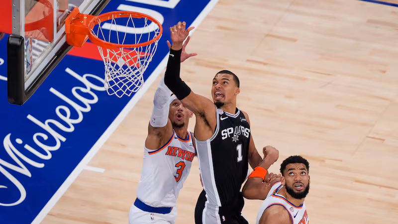 San Antonio Spurs forward Victor Wembanyama (1) shoots as New York Knicks guard Josh Hart (3)...