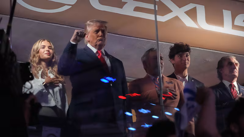 President Donald Trump gestures during the National Anthem as he attends an NBA Finals playoff...
