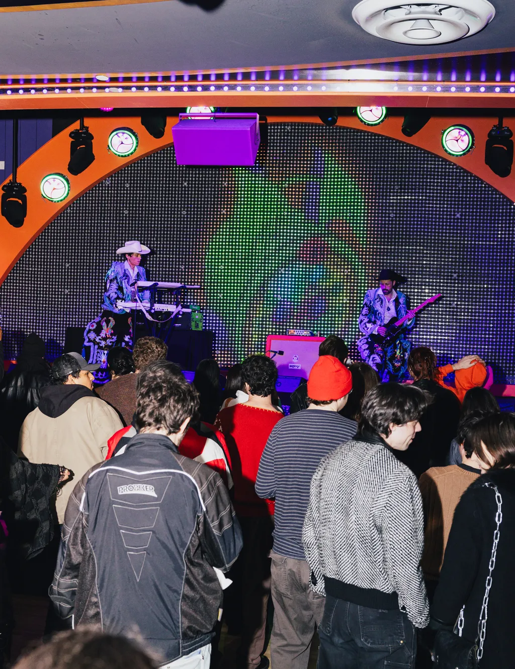 Image may contain Jon Wurster Urban Adult Person Concert Crowd Club Clothing Glove and Night Life