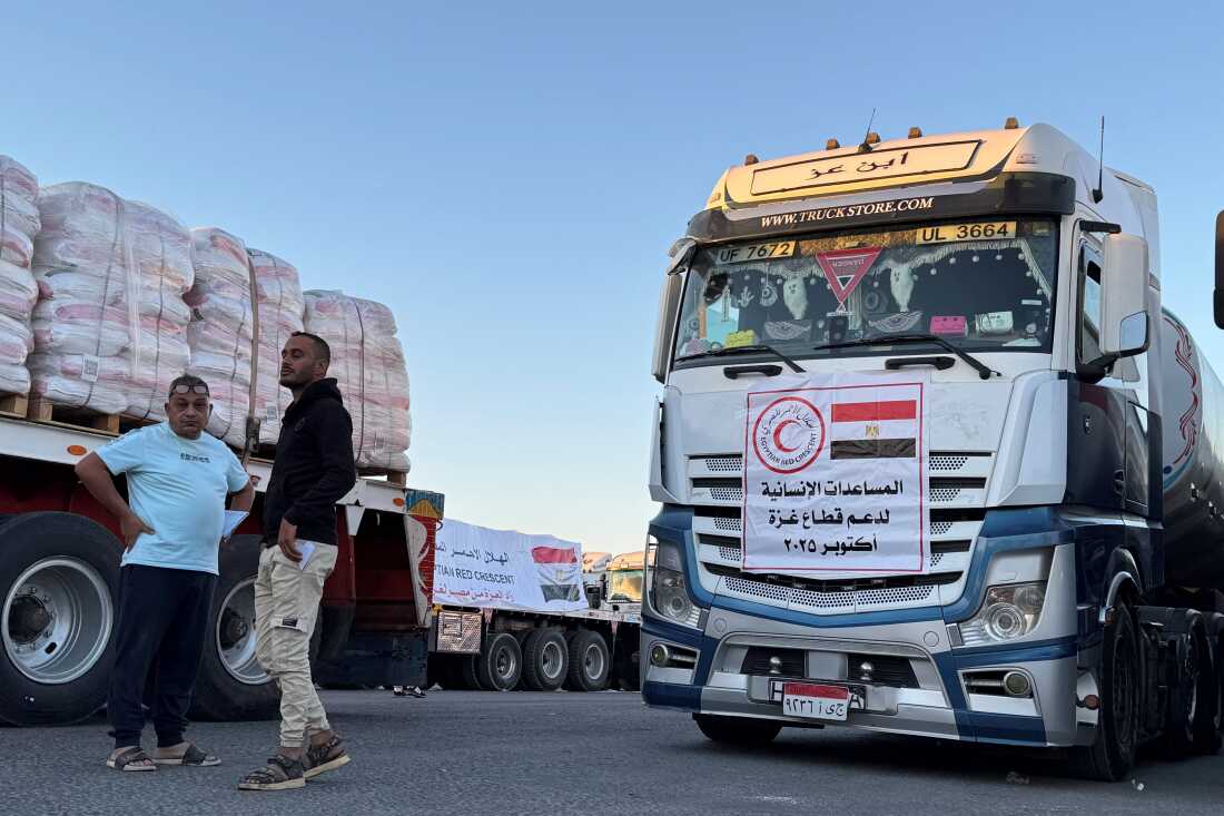 Trucks loaded with humanitarian aid on the Egyptian side of the Rafah crossing wait to cross into the Gaza Strip early on Wednesday.