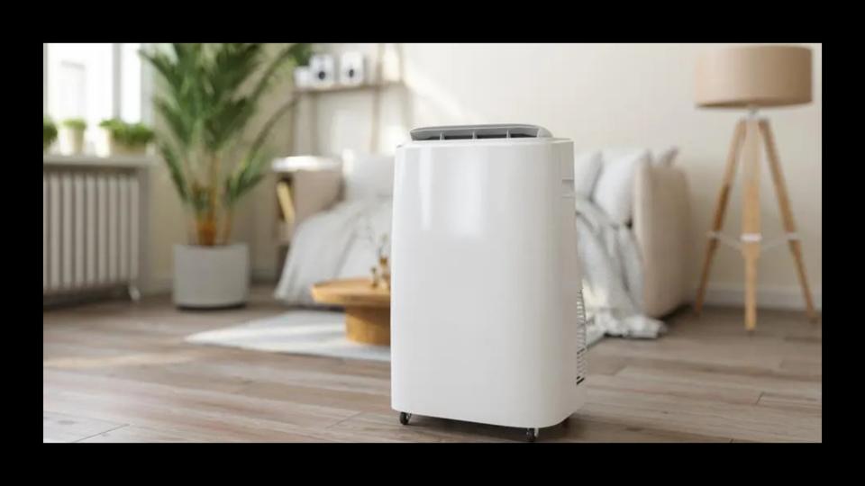 Close-up View Of Portable Air Conditioner With Blurred Living Room Background