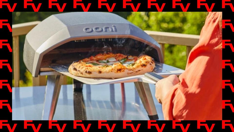 An Ooni pizza oven on sale on a black and red background.