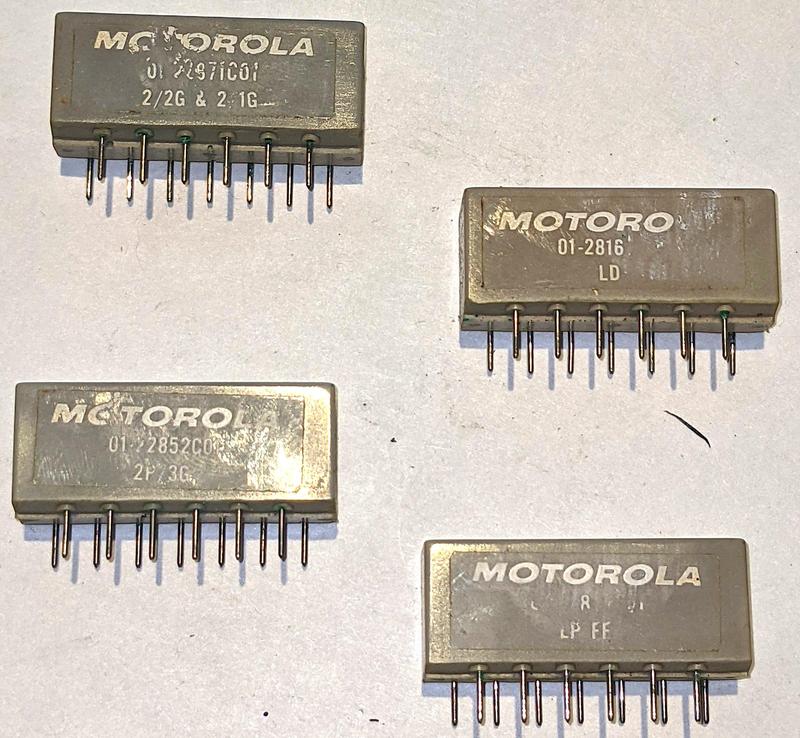 Four of the 13-pin Motorola modules. These implement logic gates (2/2G & 2/1G), lamp drivers (LD), more logic gates (2P/3G), and a flip-flop (LP FF). The modules have 13 staggered pins, ensuring that they can't be plugged in backward. Four of the 13-pin Motorola modules. These implement logic gates (2/2G & 2/1G), lamp drivers (LD), more logic gates (2P/3G), and a flip-flop (LP FF). The modules have 13 staggered pins, ensuring that they can't be plugged in backward.