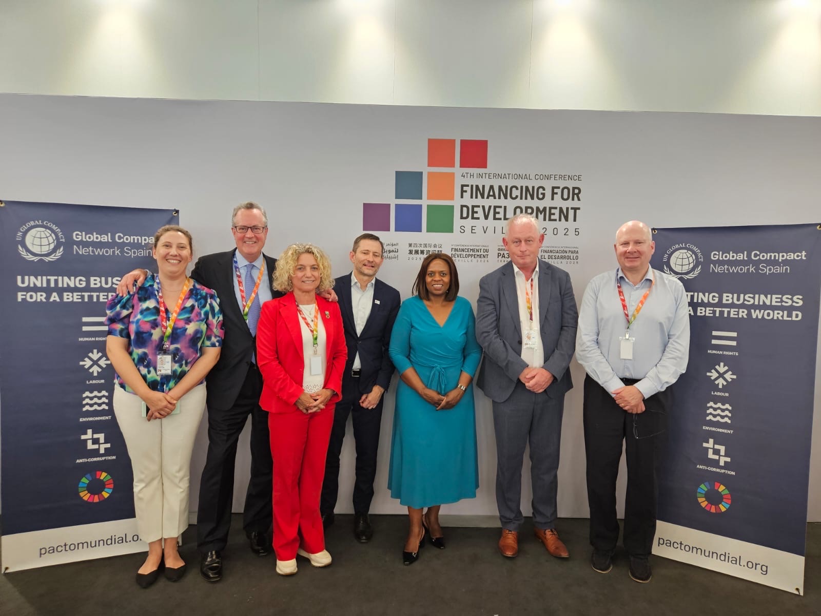 Financing for Development Conference participants smiling for a group photo including Sanda Ojiambo
